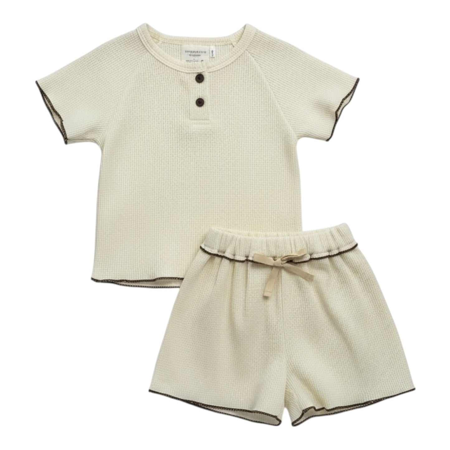Cream waffle-textured baby top and shorts set with contrast ruffle-edge stitching, displayed flat on a white background.