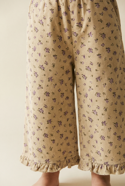 Pantalon en velours côtelé beige à fleurs et ourlet à volants