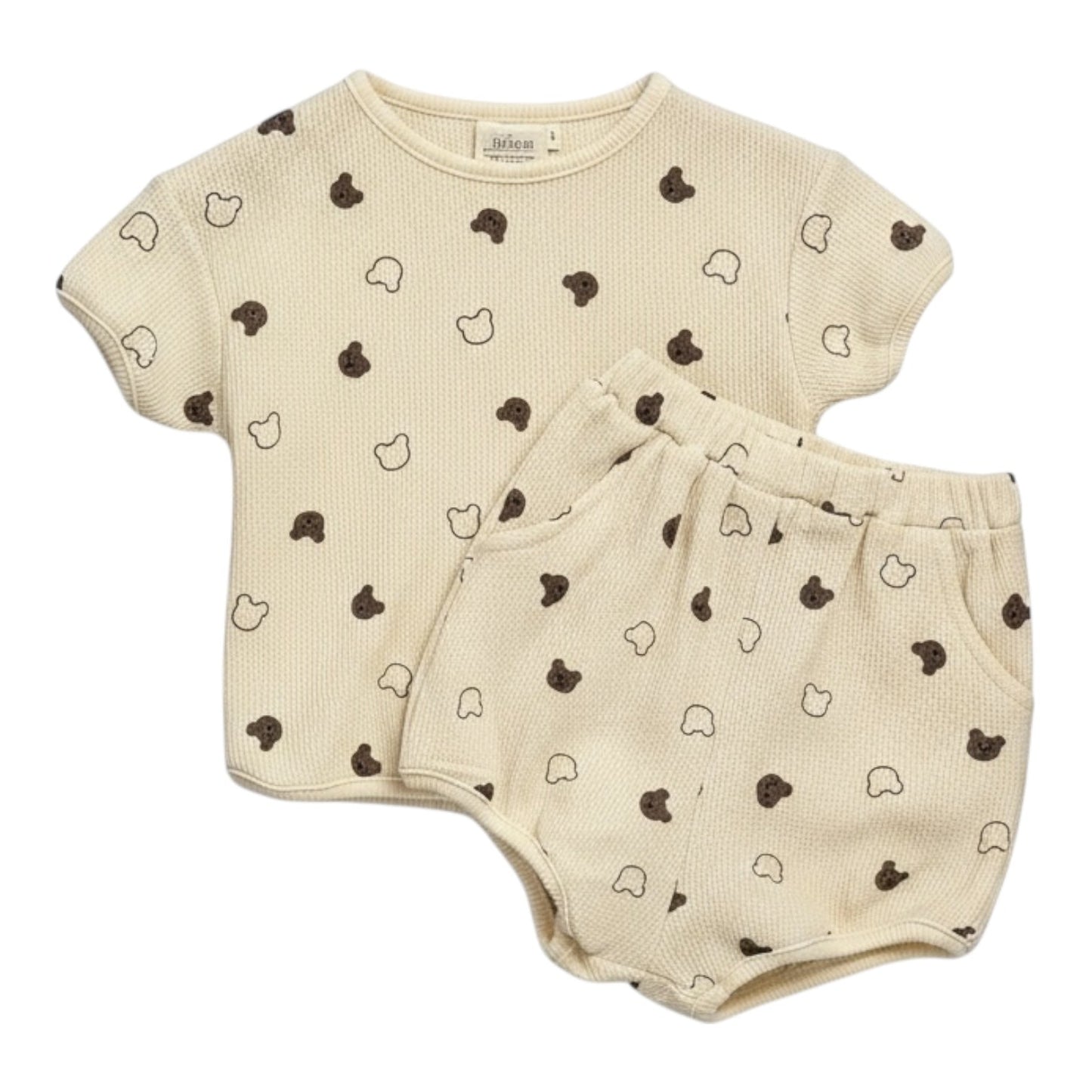 Beige waffle-textured baby top and shorts set with all-over teddy print, displayed flat on a white background.