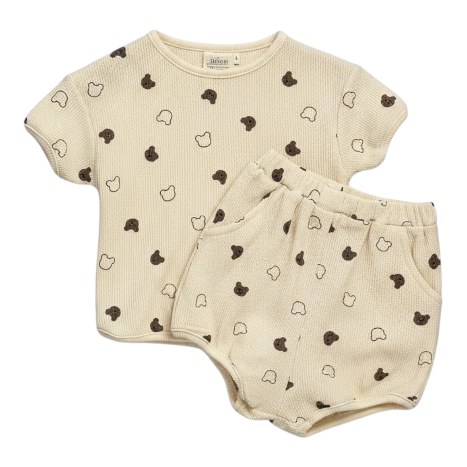 Beige waffle-textured baby top and shorts set with all-over teddy print, displayed flat on a white background.