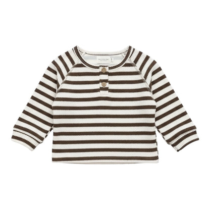Brown and white striped thick long sleeve baby top with two wooden-style buttons at the neckline, laid flat on white background.
