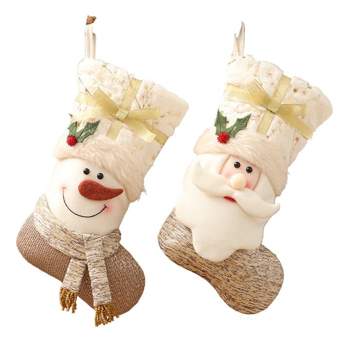 Two Nordic-style Christmas stockings, one Snowman and one Santa Claus design, in white and gold tones with faux fur trim and ribbon detail.